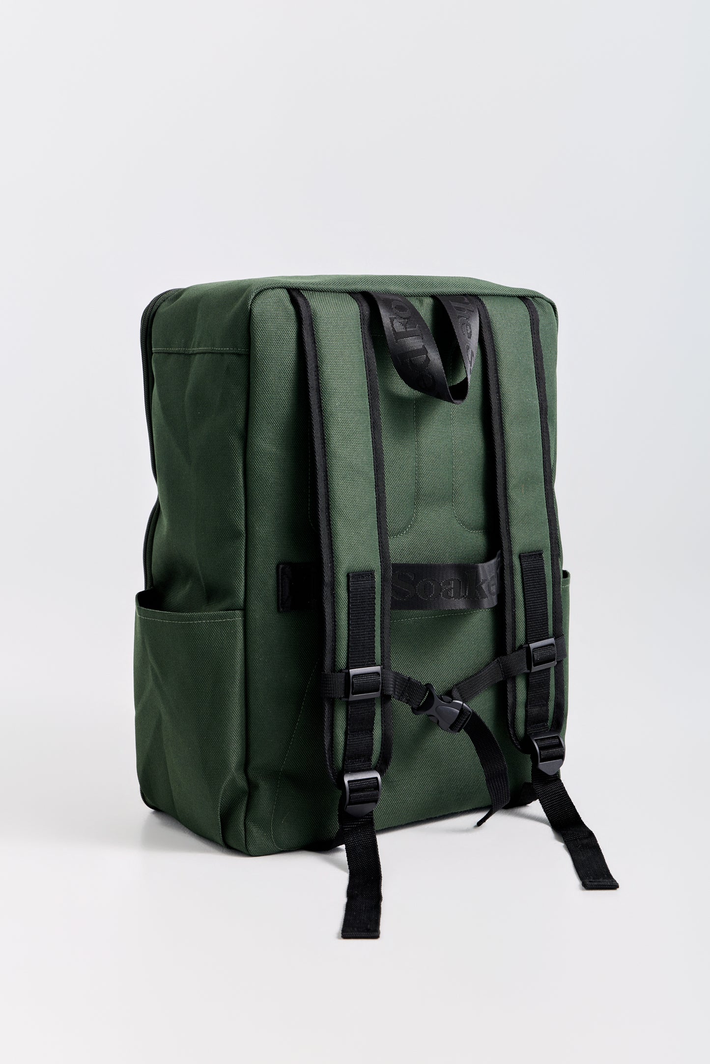 Green backpack with black straps on a white background