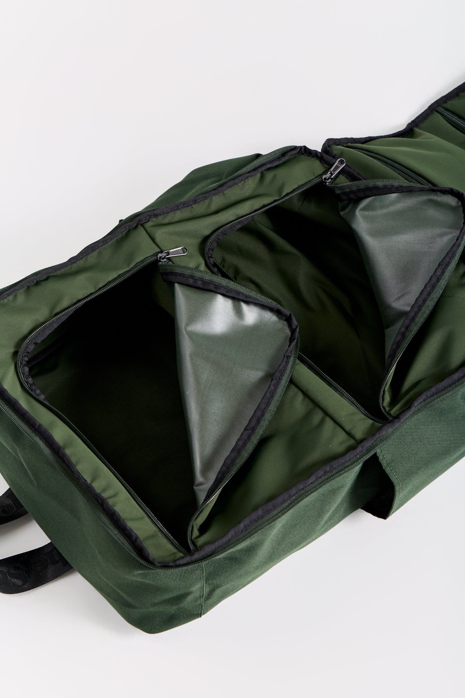 Green bag with open compartments on a white background