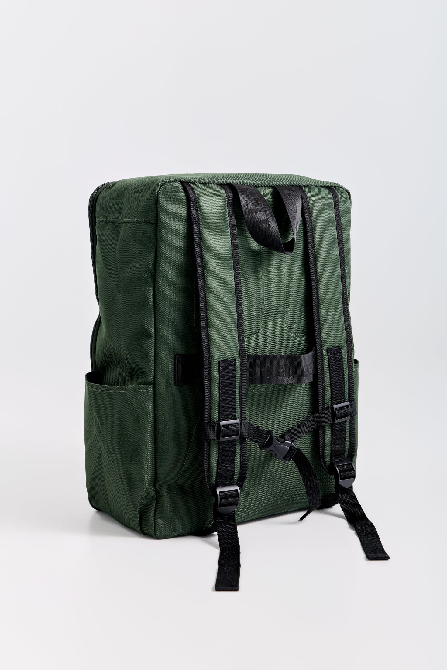 Green backpack with black straps on a white background